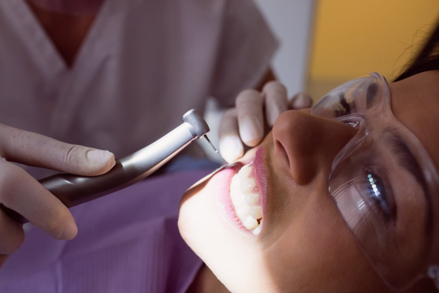 Dentist examining a patient’s teeth during a dental crown treatment procedure.