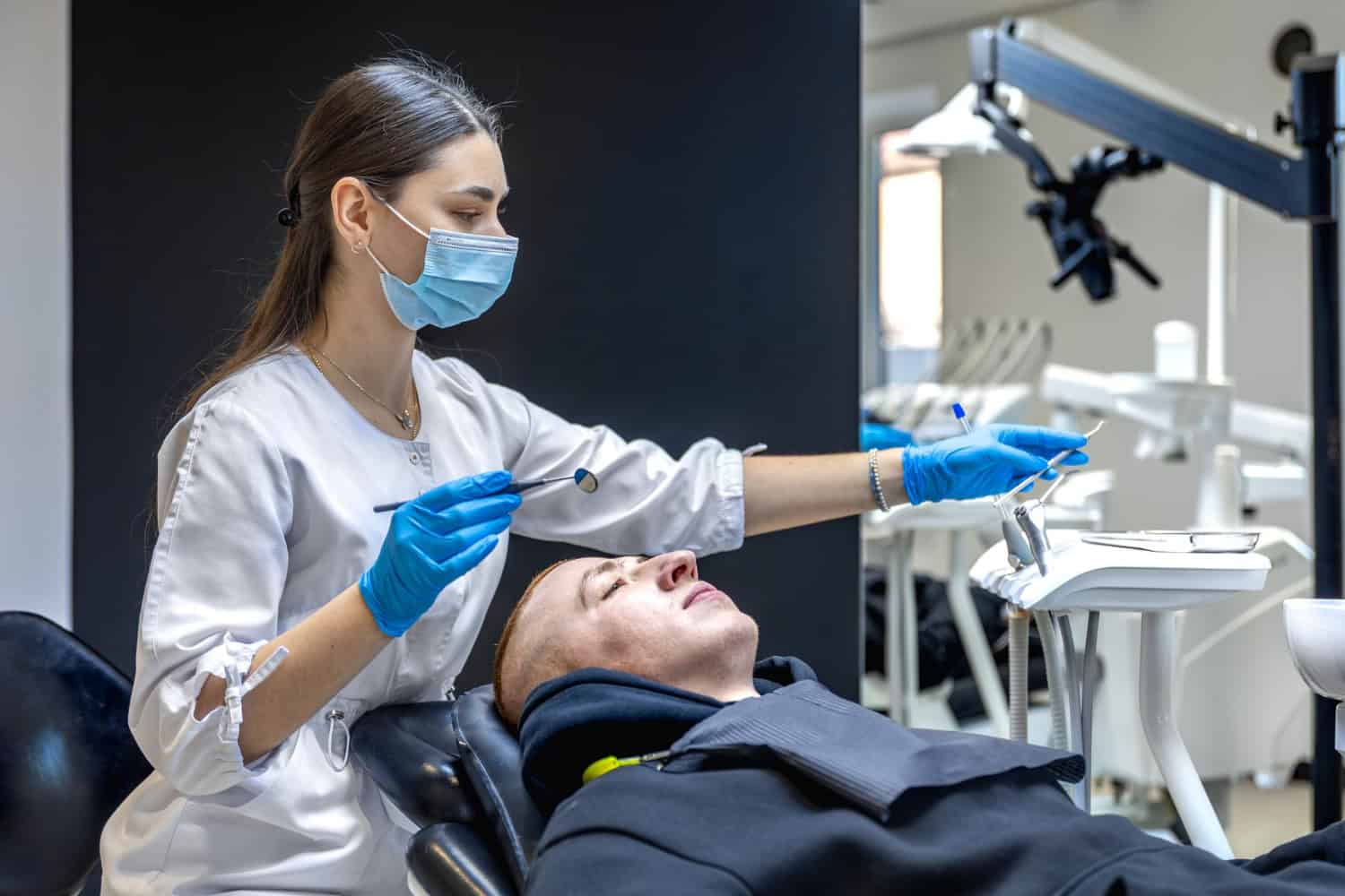 Dentist examining a patient during a dental crown consultation in a modern dental clinic.